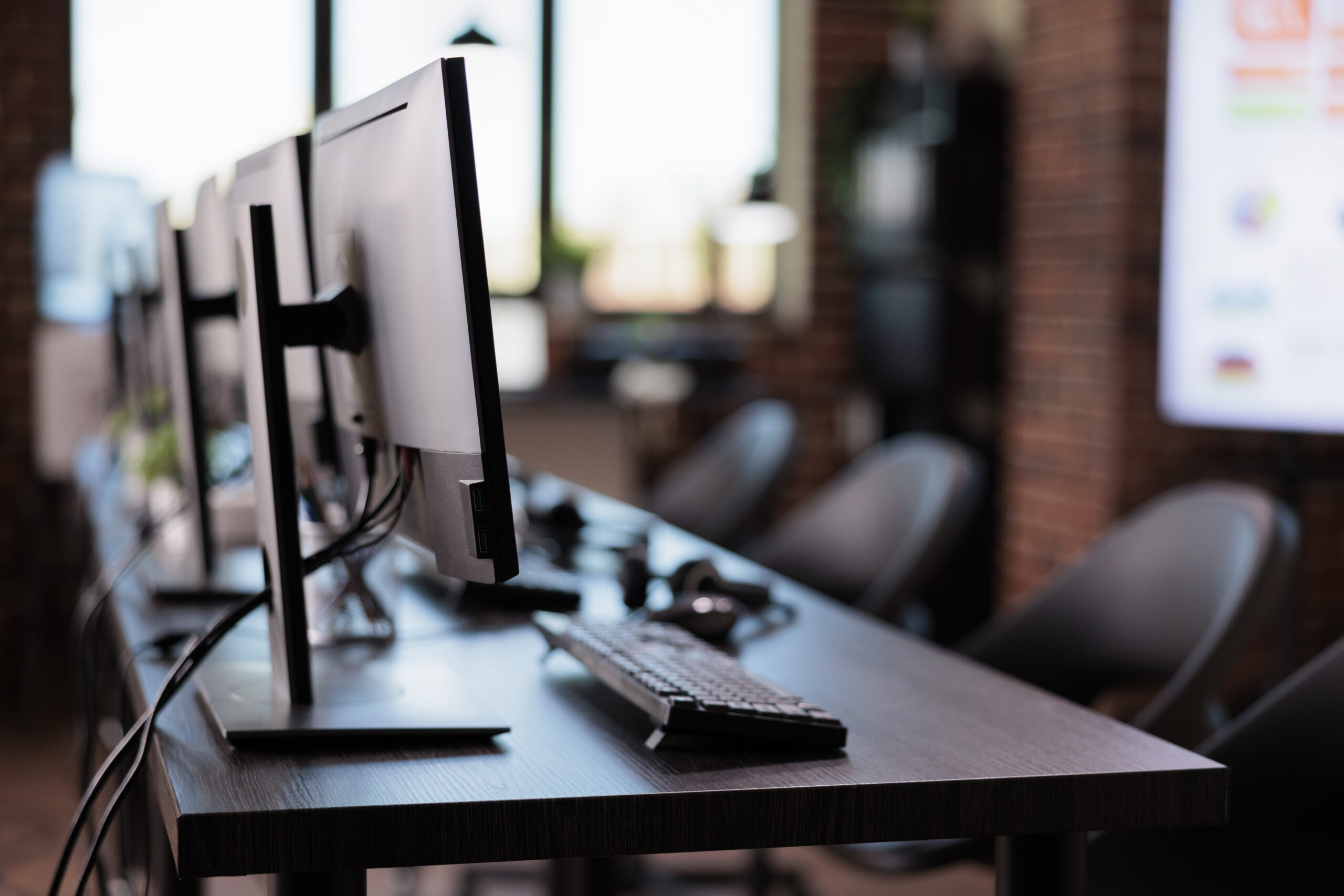No people at call center helpdesk with multiple monitors in office
